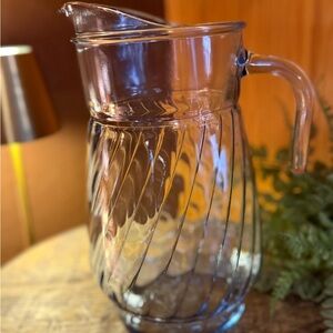 This is a vintage Anchor Hocking light blue swirl glass pitcher.